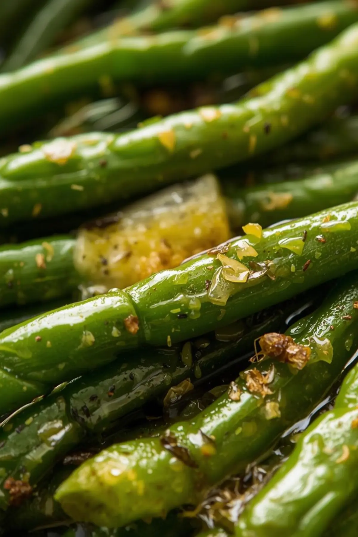 Close up of garlic butter canned green beans with visible seasonings and melted butter